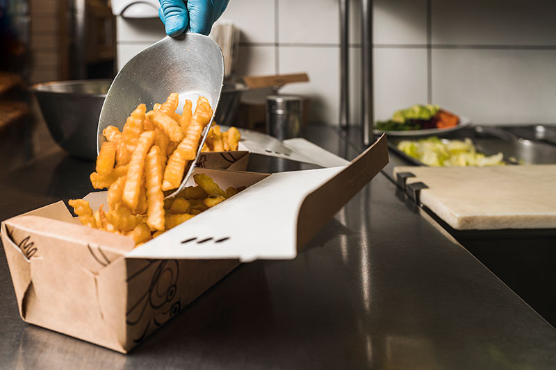 Close up of french fries cooking in golden delicious cooking oil